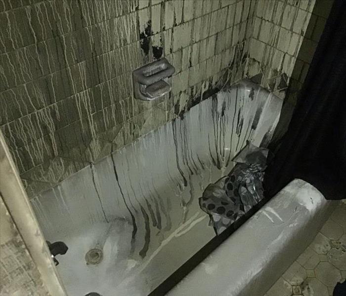 Bathtub after fire damage and before fire damage cleanup 